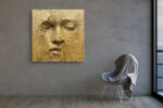 Serene human face emerging from cracked gold surface, warm gold and amber tones, dramatic mixed-media portrait canvas art