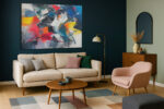 Explosive abstract acrylic painting in vivid red, cobalt blue, and near black, bold wall art canvas for living room