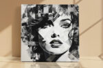 Woman's face with geometric shards and ink splatter in black and white, bold mixed-media portrait canvas wall art