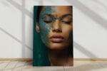 Woman's face with teal paint texture and closed eyes in deep teal and amber, moody portrait canvas for bedroom