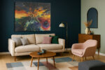 Abstract acrylic fluid art explosion in amber, crimson, and teal on near-black background, bold canvas wall art