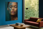 Woman's face with teal paint texture and closed eyes in deep teal and amber, moody portrait canvas for bedroom