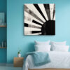 Bold monochrome rising sun with radiating rays and ink splatter, contemporary mixed-media abstract canvas for living room