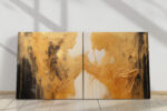 Two gold figurative forms reaching across a dark and light diptych, dramatic impasto canvas wall art for living room
